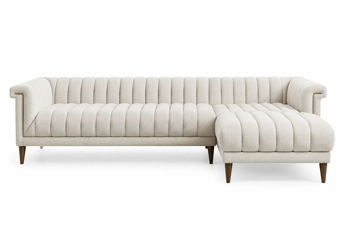 White L-shaped sofa with vertical seam backrest, modern design by WetandWestCoast, showing plush cushions and sleek upholstery.